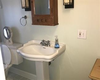pedestal sink and Oak cabinet with arts and crafts light fixtures 