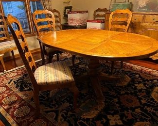 Century Furniture Co. dining table with 5 side chairs and 1 captains chair. Shown with 1 leaf and includes another leaf not photographed! Table measures 46"dia with 2 - 18" leafs. 