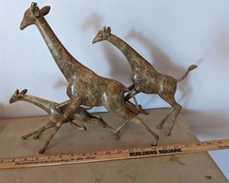 Heavy giraffe sculpture made of metal and ceramic possibly.