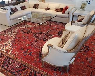 Persian hand knotted Heriz carpet, Mies van der Rohe style Barcelona table, mid-century sectional 