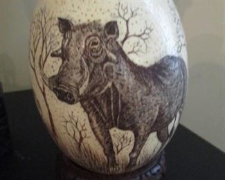 Warthog scrimshaw on ostrich egg.