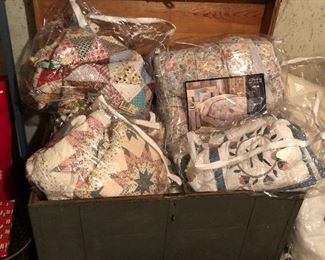 Quilts/blankets; antique storage chest.