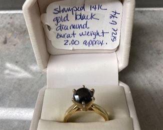 One ladies yellow gold 14k black diamond cathedral solitaire engagement ring The Black Diamond is round approximately 7.95 mm set in 6-prong head with a carat weight approximately 2.0.