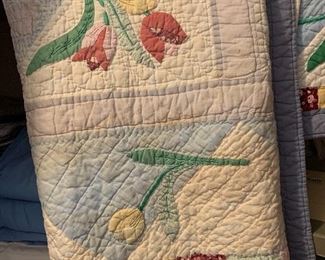 Several hand made quilts in varying condition