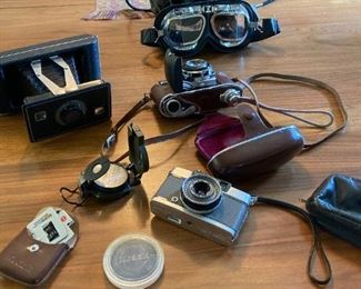 various antique cameras, vintage military leather flight cap