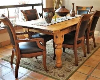 Wooden dining table and and 6 leather and wood chairs. Rug for sale too.