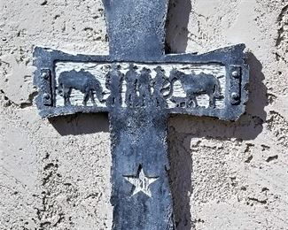 Metal cross with cowboys and horses