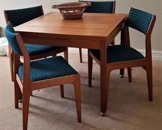 Square dining table where sides pull out to make it a rectangle table. 4 chairs with set
