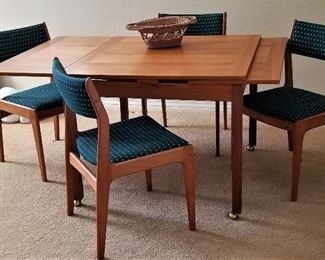 Square dining table where sides pull out to make it a rectangle table. 4 chairs with set
