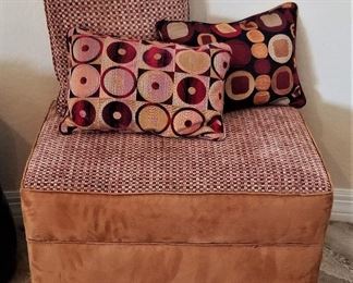 Ottoman with matching square pillows.