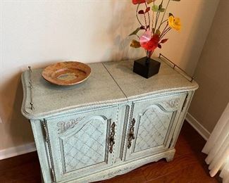 Wood bar cabinet with brass rails (28" x 38" x 16"; with panels extended 58" long); pottery; and metal floral decor