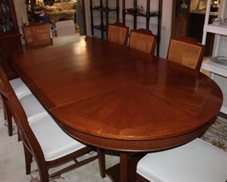 8 and 1/2' long and 48" wide, as shown, solid wood, excellent condition. Shown with three 18" leaves; 48" round without the leaves. Ten chairs, two armchairs and 8 sidecars