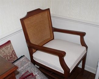 one of two armchairs with the dining table