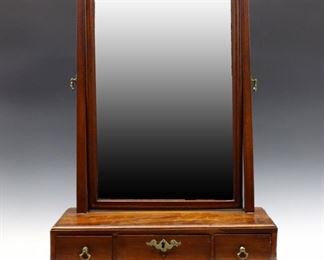 Lot 3: A late 18th century Georgian Period toilet mirror.  Mahogany construction with a molded swing mirror with tapered supports and Brass finials, base with three Oak lined dovetailed drawers and a molded base with ogee bracket feet.  Older finish with some damage to mirror silvering, drawers are sticky.  16 3/4 x 8 x 23" high.  ESTIMATE $400-600