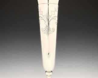 Lot 11: A George A. Henckel & Co. Sterling Silver vase.  Art Nouveau style with trumpet form, ruffled rim and etched floral detail on a weighted base.  With maker's mark and "Sterling, 289".  Minor surface wear, several light dents.  16 1/2" high.  ESTIMATE $300-500