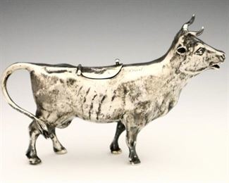 Lot 13: A late 19th century German Sterling Silver creamer.  Cow form with etched detail and hinged cover at top.  With German marks and "925".  9.22 troy ozs total weight.  Minor wear.  7 x 4 1/2" high overall.  ESTIMATE $300-500