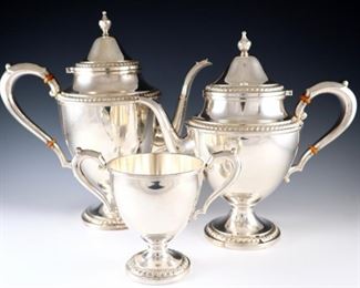 Lot 19: A Frank M. Whiting & Co. Sterling Silver tea set.  Includes a 11 1/4" high coffee pot, a 9 1/2" high teapot, and a 5 1/4" high waste bowl.  Each with maker's marks, "Sterling by Frank M. Whiting & Company" and model numbers.  51.9 troy ozs total weight.  Minor surface wear, teapot with bent finial, handle slightly loose on coffee pot.  ESTIMATE $1,500-2,500