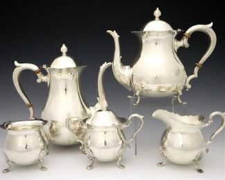 Lot 20:  A Fisher Silversmiths "Jack Shepard" pattern Sterling Silver tea set.  Includes a 9" high coffee pot, a 8" high teapot, a 5" high covered sugar, a 4" high creamer, and a 3 3/4" high waste bowl.  Each marked "Fisher Sterling" and "Jack Shepard" with model numbers.  55.29 troy ozs total weight.  Minor surface wear, handles slightly loose on coffee and teapots.  ESTIMATE $1,500-2,500