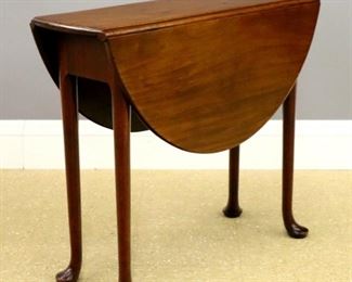 Lot 30: An 18th century British Queen Anne Period drop leaf side table.  Mahogany construction with a rounded edge top, gate-leg base, on tall cabriole legs with pad feet.  Older finish with some surface wear.  33 x 11 (37" open) x 28" high overall.  ESTIMATE $600-800