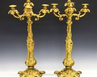 Lot 32: A pair of mid 19th century French Rococo style candelabra.  Gilded Bronze construction with cast foliate arms and stem, beaded detail and tripod base.  Some wear to Gilding and distortion to arms.  Each 25 1/4" high.  ESTIMATE $1,000-1,500