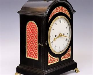 Lot 36: An 18th century Bracket clock.  8-day time and strike double fusee movement with crown wheel escapement, "Cow Tail" pendulum and solid count wheel, with a convex porcelain dial and Roman/Arabic numerals.  Ebonized case with Brass filigree panels on front and sides, Brass upper handle and molded arched top over a Brass door with deep convex glass on a molded base with Brass bracket feet.  Restored finish with minor wear, multiple hairlines in dial, running momentarily when cataloged.  14 1/2" high.  ESTIMATE $1,000-1,500