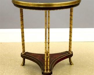 Lot 35: A 19th century French Directoire style Bronze and Marble Gueridon in the manner of Weisweiler.  Circular Black Marble top with a Bronze mounted Walnut frame supported by three pairs of bamboo turned Bronze columns on a figured Walnut stretcher base with foliate finial and three Bronze hoof feet.  Older finish with minor wear, some movement to leg connections.  23 3/4" diameter x 28 1/2" high overall.  ESTIMATE $1,000-2,000