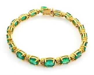 Lot 42: An Italian 14k Gold, Emerald and Diamond tennis bracelet.  Consisting of 18 oval cut emeralds, approximately 11.25 cttw, accented with 36 round brilliant cut diamonds set in pairs, approximately 1.12 cttw.  Stamped "Italy 14kt" with hallmark.  14.1 grams total weight.  Minor wear and scratches.  7 1/2" long.  ESTIMATE $2,000-3,000 