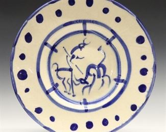 Lot 53: Pablo Picasso, Spanish, 1881-1973.  A mid 20th century Blue and White Earthenware charger, titled "La Pique" (A.R. 103).  Decorated with a stylized bullfighting scene.  Impressed "Madoura Plein Feu, Edition Picasso, Empreinte Originale de Picasso" marks and numbered "36/150" verso.  Two cracks to rim, wear to glaze, significant crazing.  15" diameter.  ESTIMATE $2,000-3,000