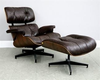 Lot 56A:  A mid 20th century Charles & Ray Eames for Herman Miller lounge chair and ottoman.  Molded Rosewood construction with Brown leather upholstery and Steel base.  "Herman Miller" paper label and tags at underside.  Minor wear and sun fading to upholstery, dull original finish, one button loose at headrest, two replaced glides at base.  Chair is 33 x 31 x 32" high overall, ottoman is 25 x 22 x 16" high overall.  ESTIMATE $1,000-2,000