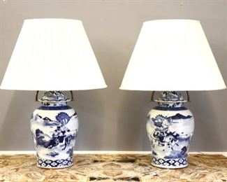 Lot 66: A pair of Chinese Blue and White baluster vases with domed covers, converted for use as lamps.  Landscape design depicting warriors and horses, with no-drill Brass fittings and pleated shades.  Slight surface wear, one vase with large chip to rim, some damage to shades.  Vases 17 3/4" high, 31" overall.  ESTIMATE $600-800