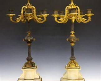 Lot 71: A pair of 19th century French Empire Period Bronze & Onyx candelabra.  Gilded Bronze construction with five upper foliate arms and Silvered detail on stepped Onyx bases with paneled Bronze plinths.  Some surface wear and slight oxidation.  Each 28" high.  ESTIMATE $1,000-1,500