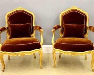 Lot 79: A pair of 19th century French fauteuils.  Gilded wood frames with carved floral crests, shaped open arm and cabriole legs with carved detail, upholstered backs, arms and seats in Burgundy Velvet with embroidered detail.  Some wear and minor loss to Gilding, minor wear to fabric.  Each 38 1/2" high.  ESTIMATE $2,000-3,000