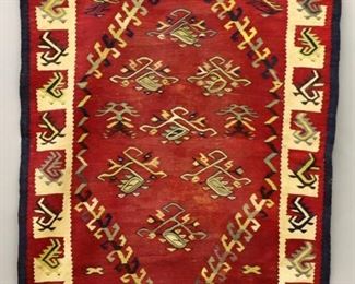 Lot 77: A 3.4' x 5.0' late 19th century Sarkoy Kilim rug.  Multicolor geometric designs on a Brick Red field with repetitive geometric border.  Some wear, fading and minor damage, hanging panel stitched to back.  ESTIMATE $1,500-2,500