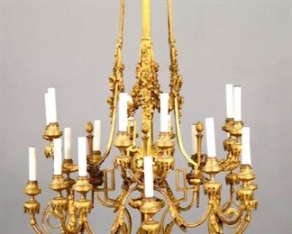 Lot 87: An early 19th century French Empire Period Gilded Bronze chandelier.  Four sets of five arms in two tiers, with a central urn and floral swags.  Original Gilded Bronze finish with some wear, has been electrified.  28 1/2 x 37" high overall plus chain.  ESTIMATE $3,000-4,000