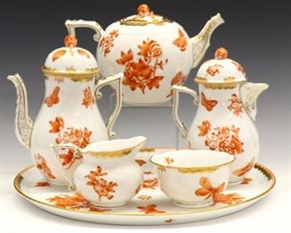Lot 97: A 20th century Herend porcelain tea serving set.  Rust color floral design with moths and Gilded detail.  Includes a 14 1/2" long serving tray with a 8 1/2" high coffee pot, 5 1/2" high teapot, 8" high hot milk pot, creamer and open sugar bowl.  Blue printed marks.  Slight wear, light surface scratches on tray.  ESTIMATE $800-1,200
