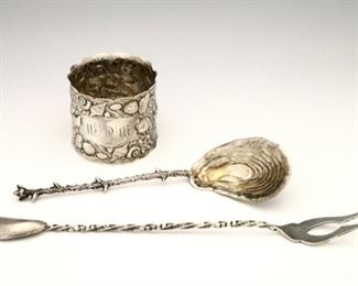 Lot 12: Three Gorham "Narragansett" pattern Sterling Silver pieces.  Including an olive/pickle fork, a spoon with Gold washed bowl and napkin ring, all with marine theme.  Each with maker's mark, "Sterling" and model numbers.  2.31 troy ozs total weight.  Minor wear overall, wear to Gold wash, napkin ring monogrammed.  Up to 7 1/2" long.  ESTIMATE $300-400