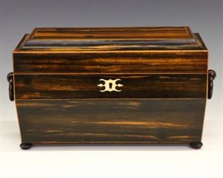 Lot 96: An early 19th century British William IV Period tea caddy.  Palisander wood case in sarcophagus form with Boxwood stringing, molded top, double ring handles and flattened bun feet.  Opens to reveal two tea boxes and a central cut glass mixing bowl.  Polished finish with minor wear and slight shrinkage.  12 x 6 x 7" high overall.  ESTIMATE $800-1,200