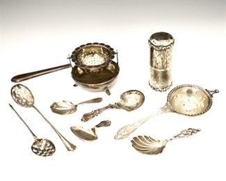 Lot 101: Nine late 19th to early 20th century British Sterling Silver tea accessories.  Includes caddy spoons, strainers, etc. by various makers.  6.67 troy ozs total weight.  Some with minor wear.  ESTIMATE $300-500