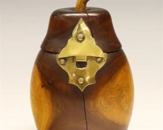 Lot 102: An early 19th century Georgian pear form tea caddy.  Lignum Vitae construction with a hinged cover and foil lining.  Some wear and shrinkage cracks.  4 1/4" high.  ESTIMATE $300-400