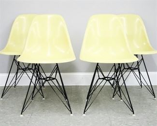 Lot 104: Four mid 20th century Charles & Ray Eames for Herman Miller shell chairs.  Shaped fiberglass seats in Canary Yellow with coated Eiffel tower bases.  "Herman Miller" paper labels at undersides of two chairs.  Some wear, minor discoloration to fiberglass.  18 1/2 x 19 x 30 1/2" high overall.  ESTIMATE $400-600