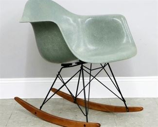 Lot  107: A mid 20th century Charles & Ray Eames for Herman Miller shell rocking chair.  Shaped fiberglass seat in Seafoam Green on coated Eiffel tower bases with Birch rockers.  Some wear, minor discoloration to fiberglass.  25 x 25 x 27" high overall.  ESTIMATE $400-600