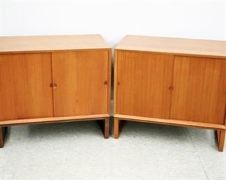 Lot 106: Two mid 20th century Danish modern record cabinets.  Teak construction with sliding doors and half moon recessed pulls, opens to reveal two compartments with a single shelf, one also with slotted interior for record storage.  Minor surface wear, light scratches and discoloration to finished tops.  Each 31 1/2 x 18 x 28 1/4" high overall.  ESTIMATE $400-600