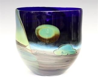 Lot 119: John Lewis, American, b. 1942.  A 1970's art glass vase depicting a moonscape in shades of Cobalt Blue and Green.  Signed "Lewis" and numbered "78-286" at underside.  Minor surface wear, a few light scratches.  6 1/2" diameter x 6 1/2" high.  ESTIMATE $200-400