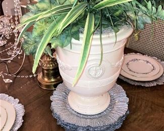 More silver chargers; artificial arrangement in a white urn