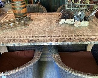 This granite top patio table has a firepit in the center.(Chairs - as is - sold separately from table )