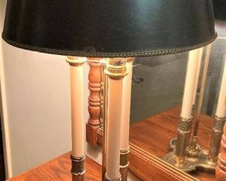 A three-candlestick brass lamp with dark shade