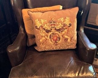 One of two leather wingback chairs; decorative pillows