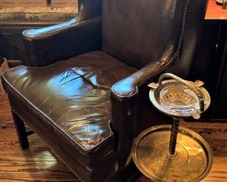The other leather wingback chair; brass ashtray table