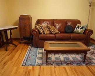 glass top coffee table, rug, couch, victrola, marble top westlake style table