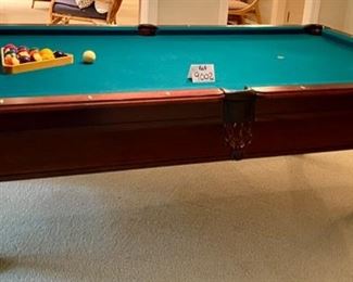 Lot 9002-A $1595.00. AMF 8' Pool Table, Stately table crafted in cherry, with green felt table  and sides, leather pockets, claw and ball feet, includes balls, triangle, all accessories, 4 pool cues and a bridge. If you've been looking for a pool table that looks as great as it plays, this is your table!